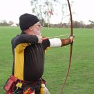 A longbow archer takes aim